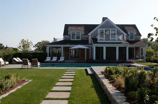 title:A simple linear walkway leads to the pool area from the guest house.